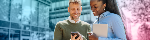man and woman looking at the phone
